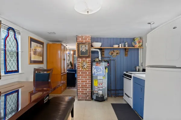 a view of a kitchen with fridge and workspace