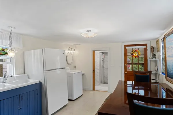 a white refrigerator freezer sitting in a kitchen with stainless steel appliances granite countertop furniture and a refrigerator