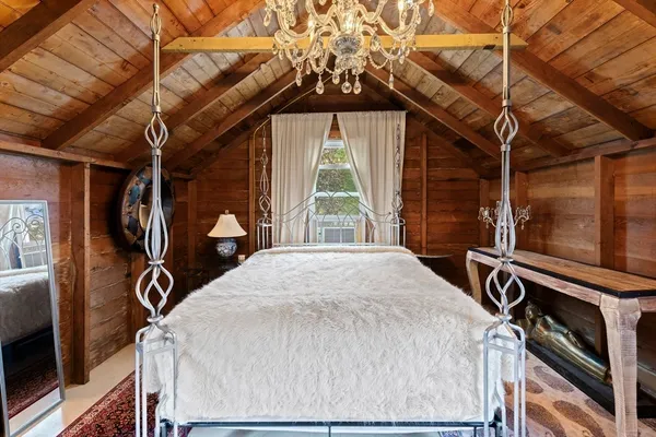a view of a bedroom with a bed and a window