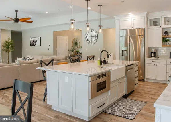a bathroom with a tub a sink and glass door