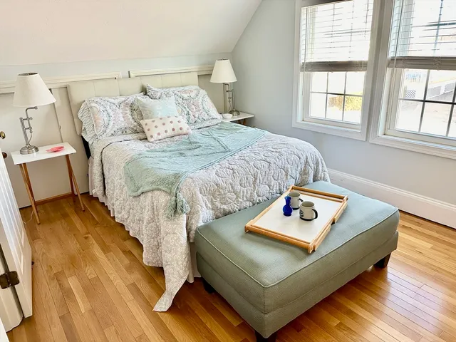 a bed sitting in a bedroom next to a window