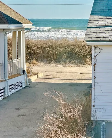 a view of a porch with a floor to ceiling window and outside view