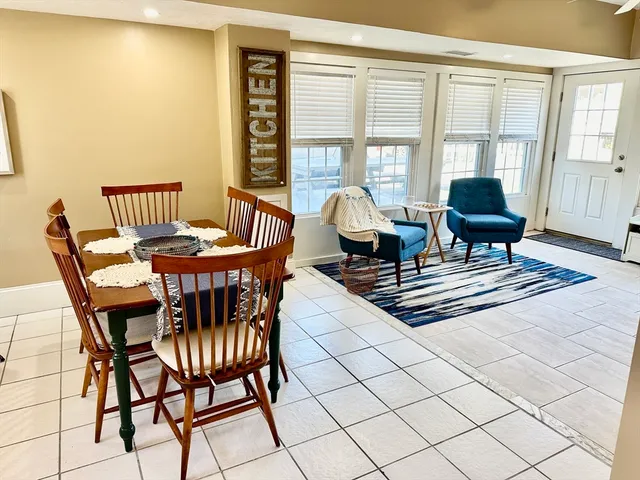 a dining room with furniture and wooden floor