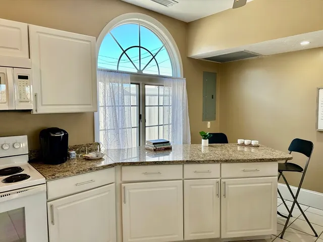 a kitchen with stainless steel appliances granite countertop a stove a sink and a granite counter tops