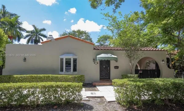 a front view of a house with garden
