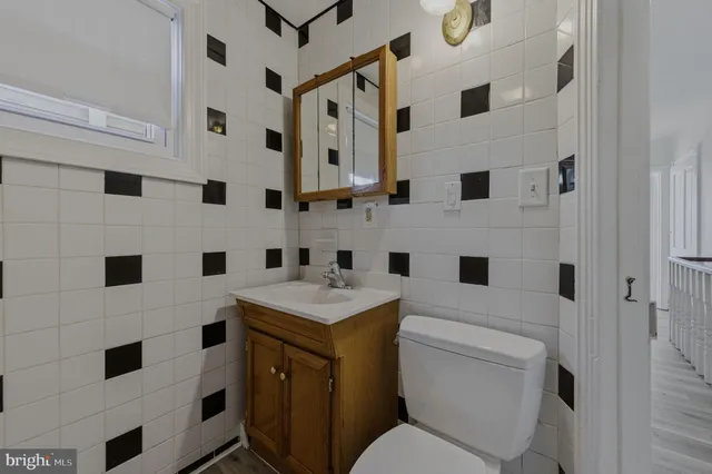 a white house with sink a washer and dryer