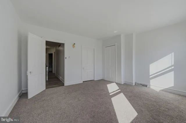a view of an empty room and closet area