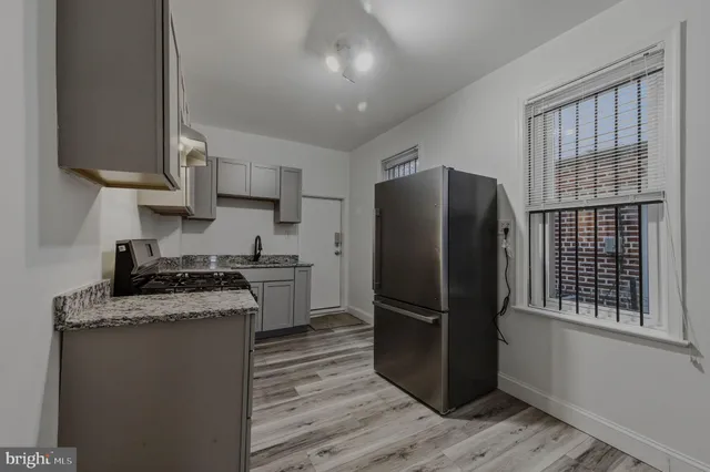 a kitchen with a refrigerator sink and cabinets