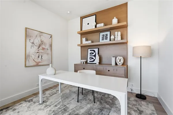 a workspace with furniture and painting on wall