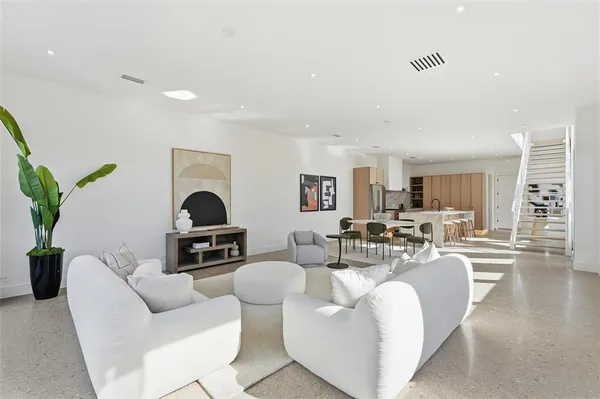 a living room with furniture a couch and a dining table