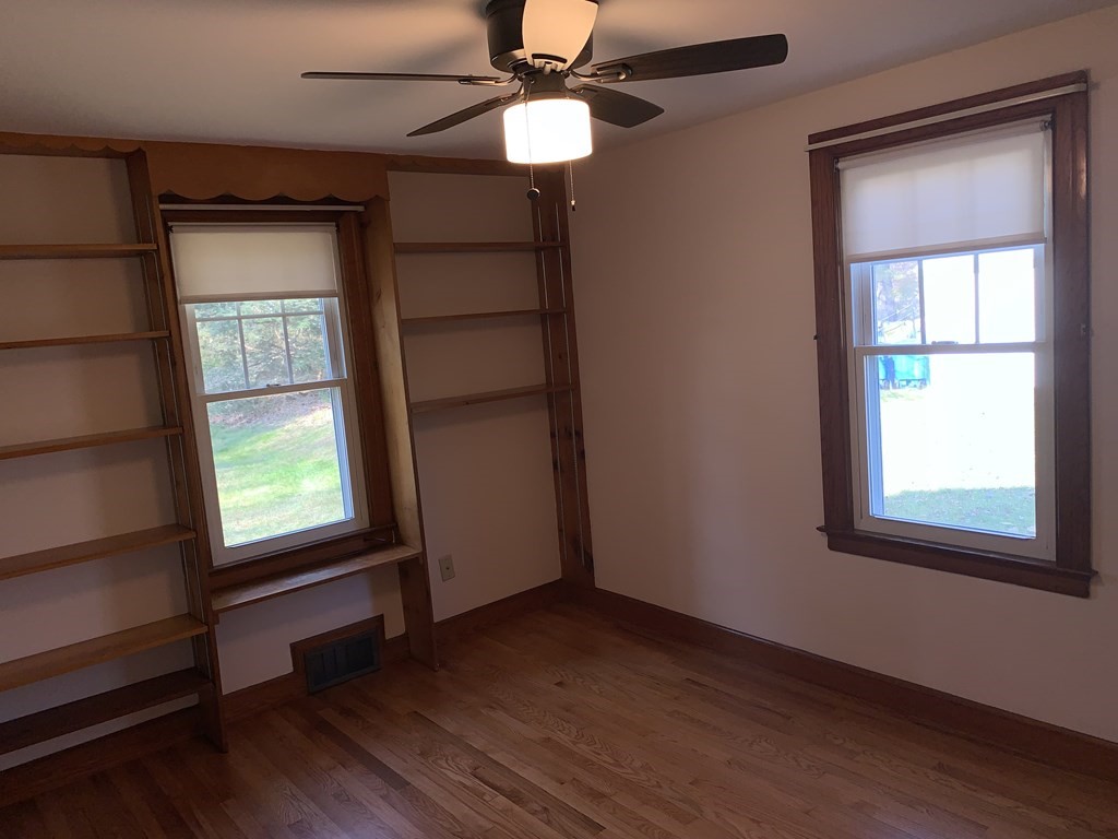 174 Palmer Road Monson, MA 01057 - Photo 14 of 23 an empty room with wooden floor chandelier fan and windows
