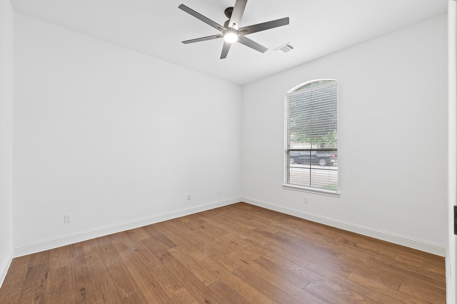 114 North Saddle Ridge Drive Cedar Park, TX 78613 - Photo 22 of 40 an empty room with wooden floor ceiling fan and windows