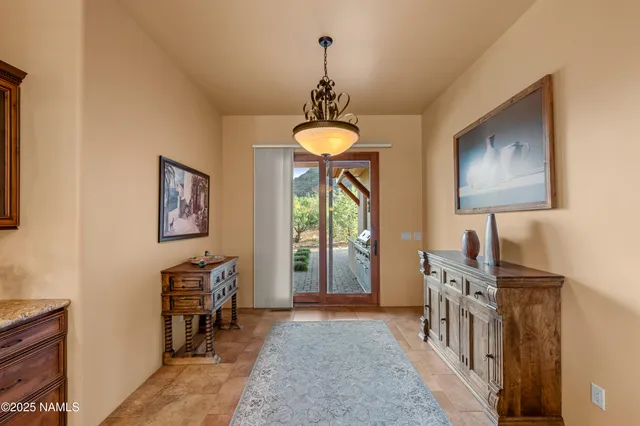 a bedroom with furniture a chandelier and a window
