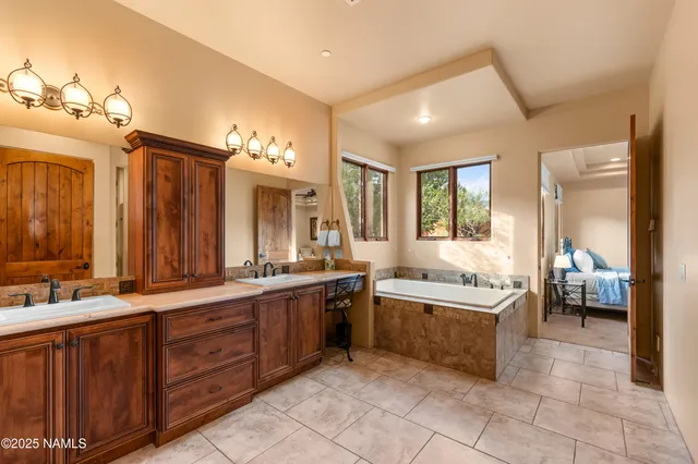 a large bathroom with a large tub and sink