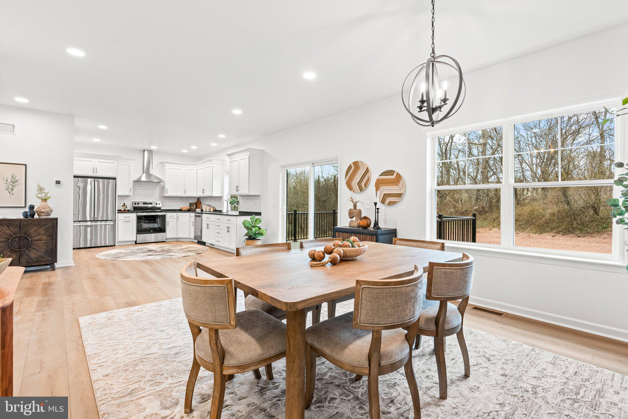 66 Brookview Drive Newport, PA 17074 - Photo 15 of 61 a dining room with wooden floor a chandelier a glass table and chairs