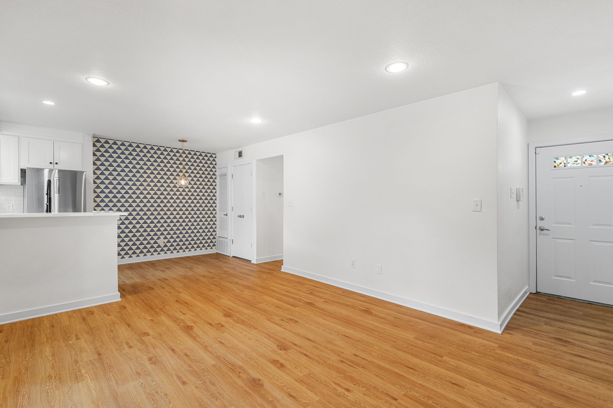 3601 Menchaca Road, Unit 110 Austin, TX 78704 - Photo 37 of 37 An open floorplan with wooden floors and modern recessed lighting creates an inviting atmosphere.