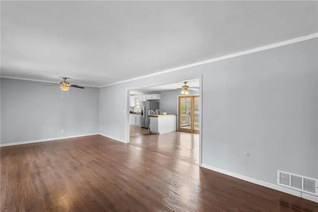 a view of an empty room with a fireplace and a window