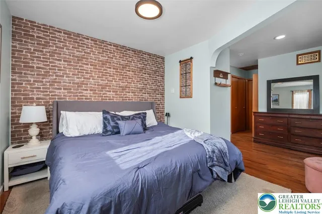 a bedroom with a bed and a dresser