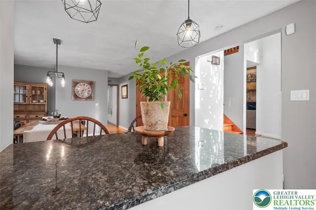 a view of a dining table chairs and chandelier