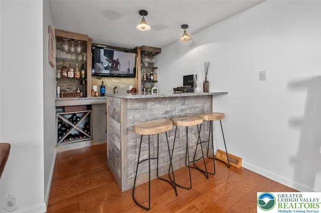a kitchen with stainless steel appliances a dining table chairs and a refrigerator