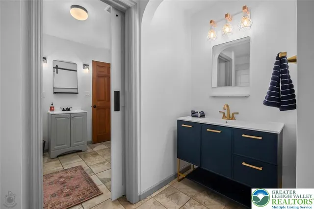 a view of a bathroom with a sink and mirror