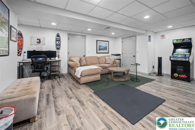 a living room with furniture a flat screen tv and a fireplace