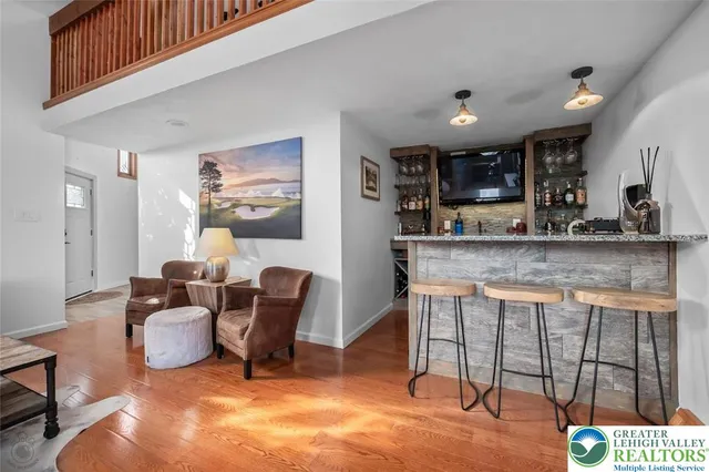 a kitchen with granite countertop a stove a sink a dining table and chairs