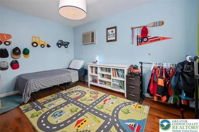 a bedroom with a bed and a bookshelf