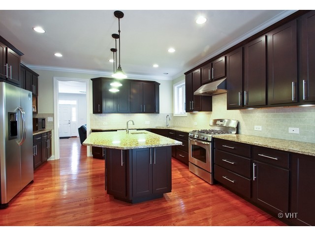 438 Briarhill Road Glenview, IL 60025 - Photo 3 of 17 a kitchen with stainless steel appliances granite countertop wooden cabinets a stove top oven a sink and dishwasher