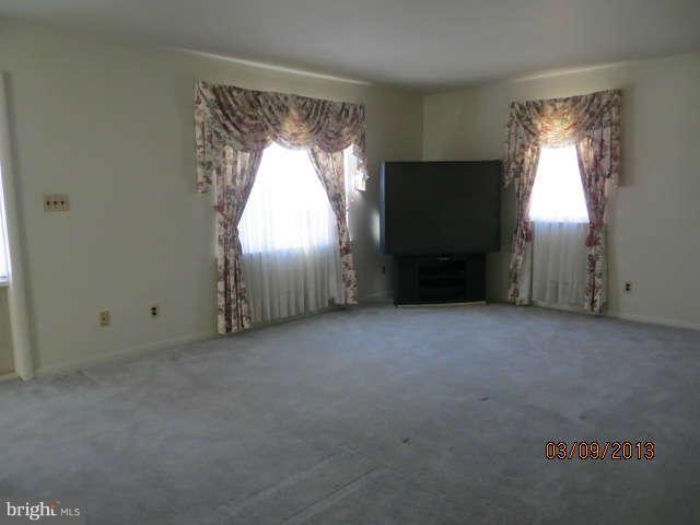 408 Crosby Road Baltimore, MD 21228 - Photo 2 of 17 an empty room with windows and closet