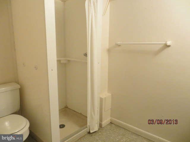 408 Crosby Road Baltimore, MD 21228 - Photo 11 of 17 a bathroom with a toilet and shower