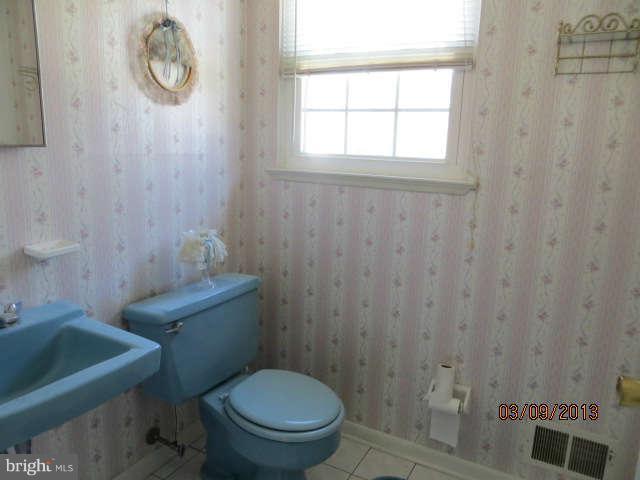408 Crosby Road Baltimore, MD 21228 - Photo 8 of 17 a bathroom with a toilet a sink and a shower