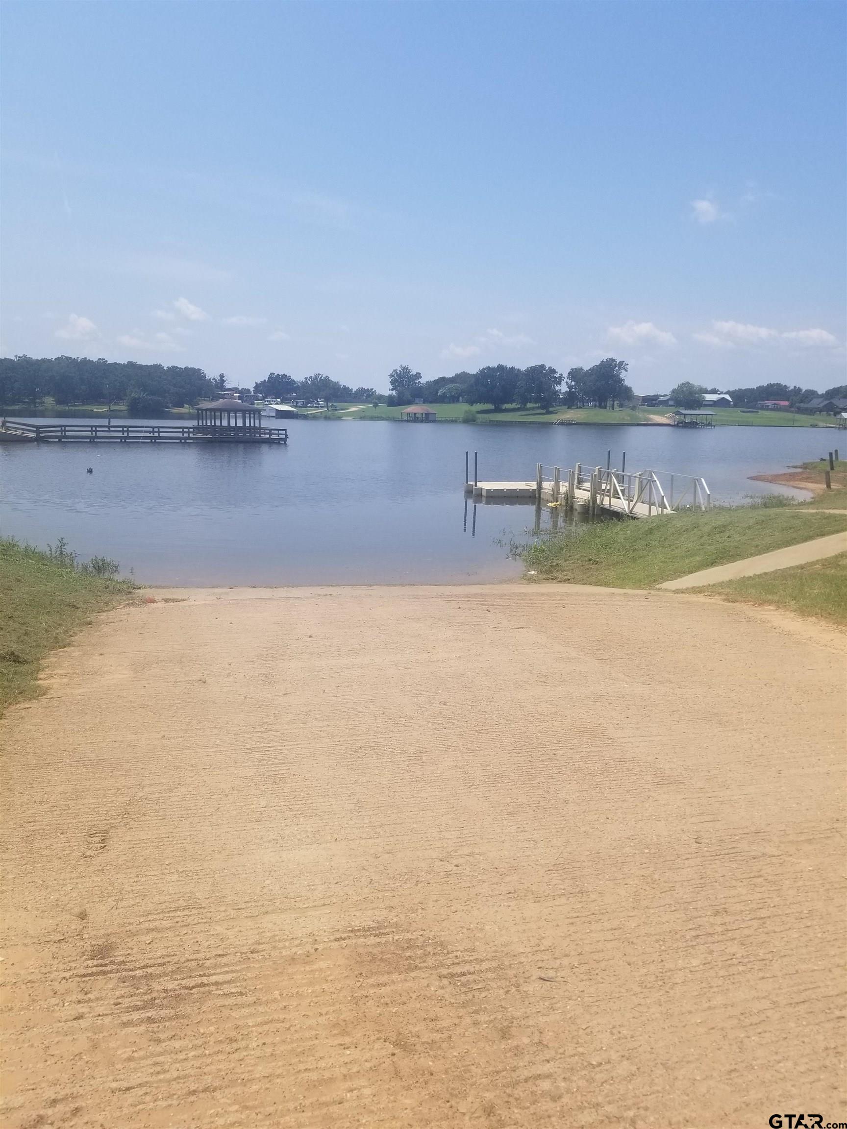 281 Indian Gap Quitman, TX 75783 - Photo 18 of 30 a view of a lake with houses in the background