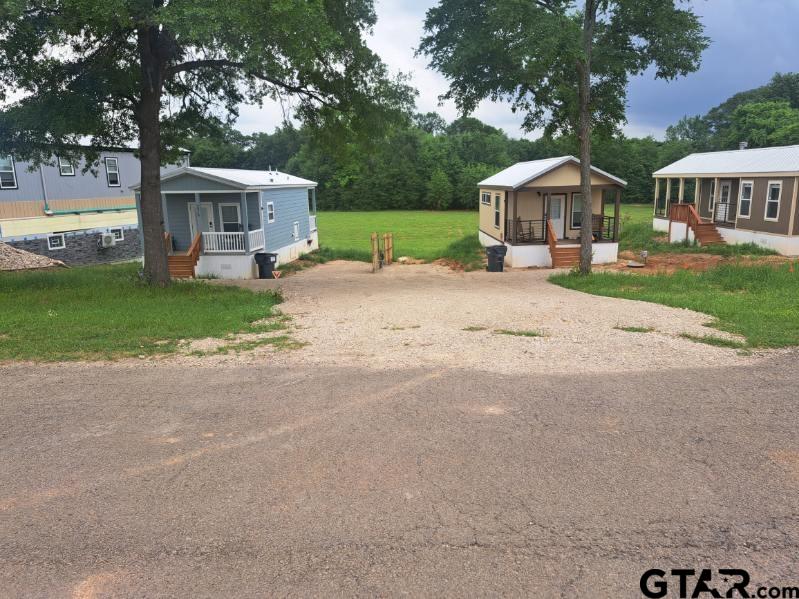 281 Indian Gap Quitman, TX 75783 - Photo 22 of 30 a front view of a house with garden and trees