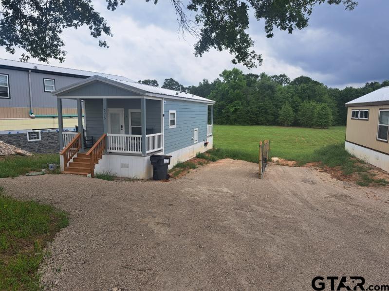 281 Indian Gap Quitman, TX 75783 - Photo 23 of 30 front view of a house with a yard and potted plants