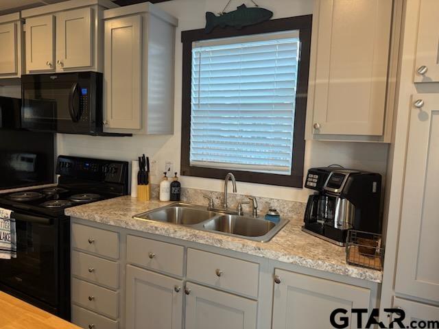 281 Indian Gap Quitman, TX 75783 - Photo 27 of 30 a kitchen with granite countertop a sink a stove and cabinets