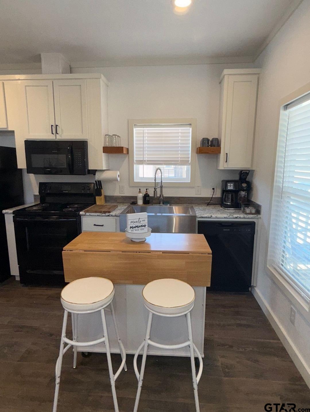 281 Indian Gap Quitman, TX 75783 - Photo 6 of 30 a kitchen with stainless steel appliances granite countertop a table chairs stove and refrigerator
