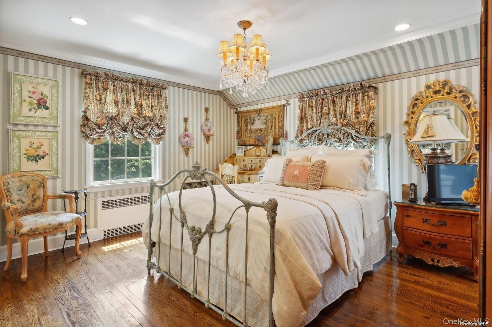 1345 Harbor Road Hewlett, NY 11557 - Photo 20 of 36 a bedroom with a bed and a chandelier