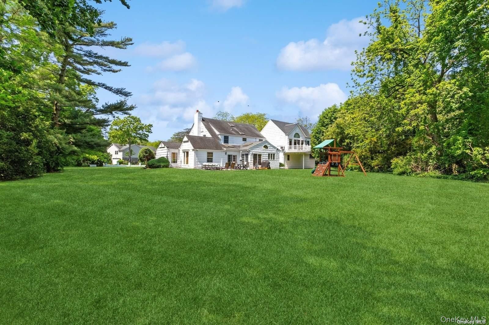 1345 Harbor Road Hewlett, NY 11557 - Photo 33 of 36 a view of a house with a small yard and sitting area