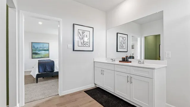 a bathroom with a double vanity sink a mirror and shower