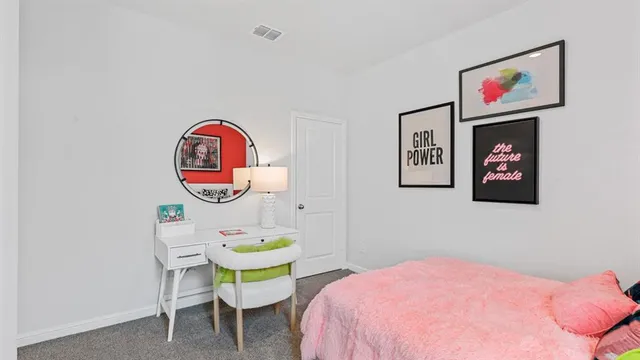 a bed room with a bed and a painting on the wall