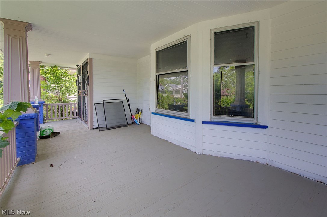 1872 Lampson Road Cleveland, OH 44112 - Photo 4 of 21 Expansive covered porch featuring a painted floor, architectural columns, and wood railings