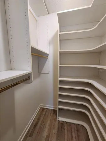 a view of walk in closet with empty racks