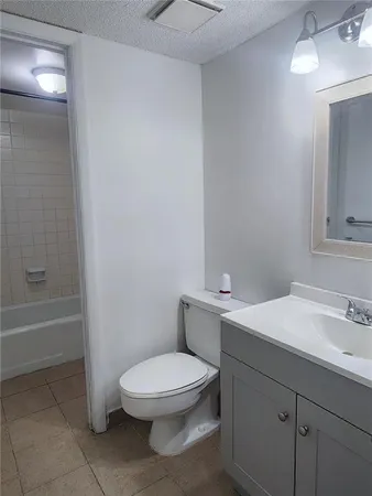 a bathroom with a toilet a sink and bathtub