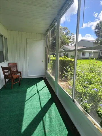 a view of a porch with furniture and garden