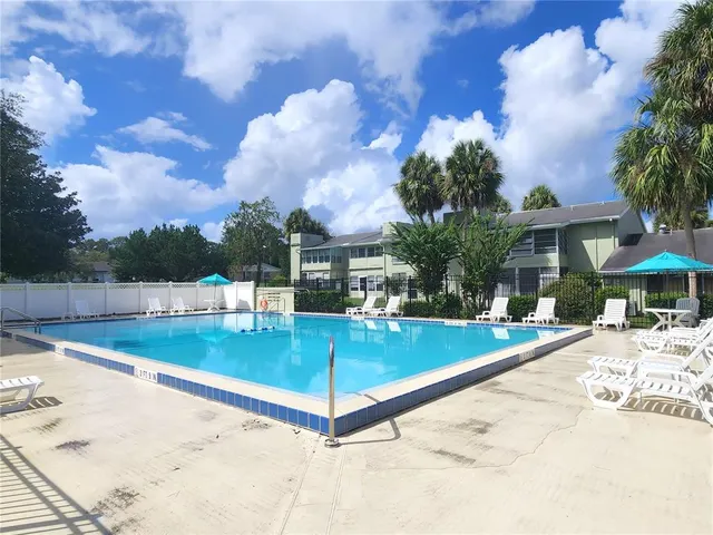 a view of a backyard with swimming pool