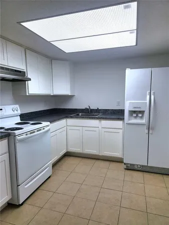 a kitchen with stainless steel appliances granite countertop a sink and a stove