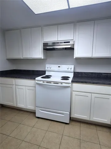 a kitchen with white cabinets