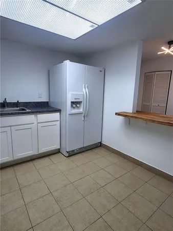 a kitchen with granite countertop a cabinets and white appliances