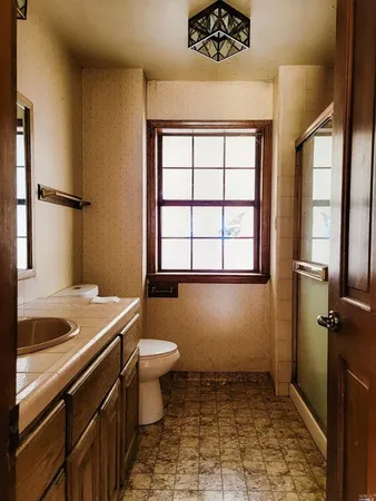 a bathroom with a sink toilet and shower
